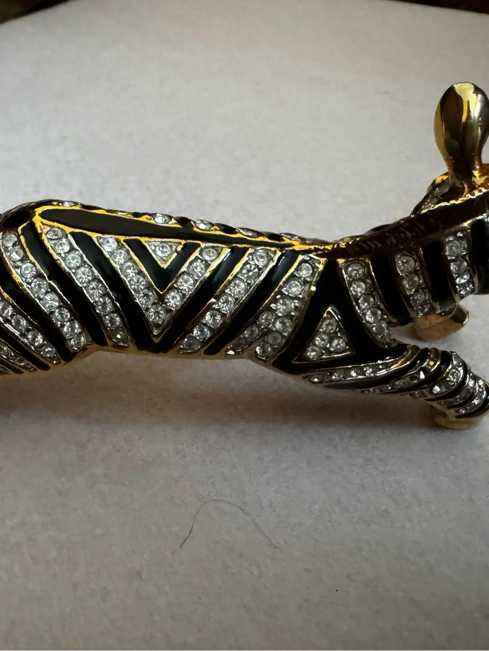 Vintage 1980s gold and black enamel over the shoulder brooch
